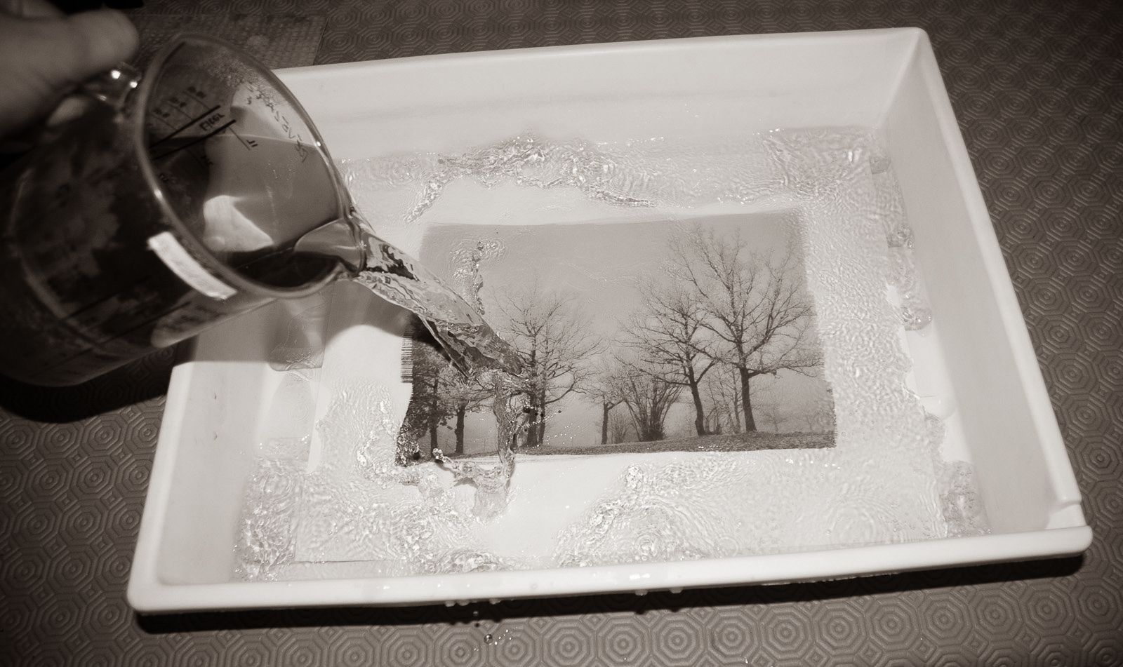 Pouring the developer over the exposed paper
